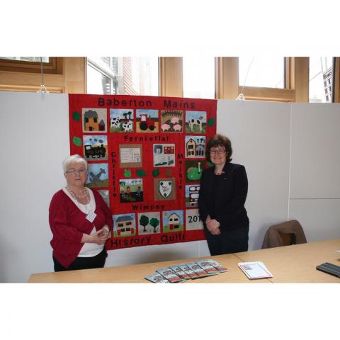 Sarah Boyack and Muriel Adam with quilt displayed in Scottish Parliament May 2015 